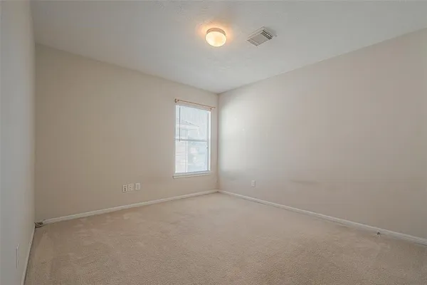 an empty room with a empty space and windows