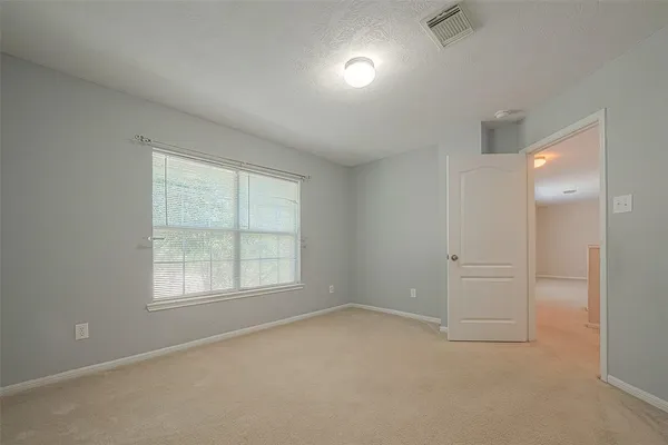 an empty room with windows and closet