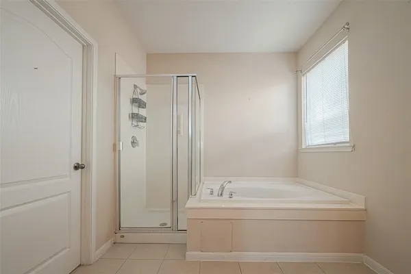 a bathroom with a bathtub and shower