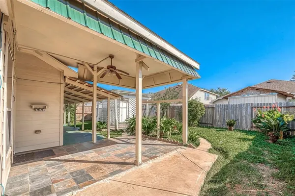 a front view of a house with a tree