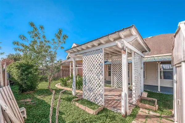 a view of a backyard with wooden fence