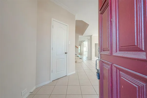 a view of a hallway with two windows and a cabinet