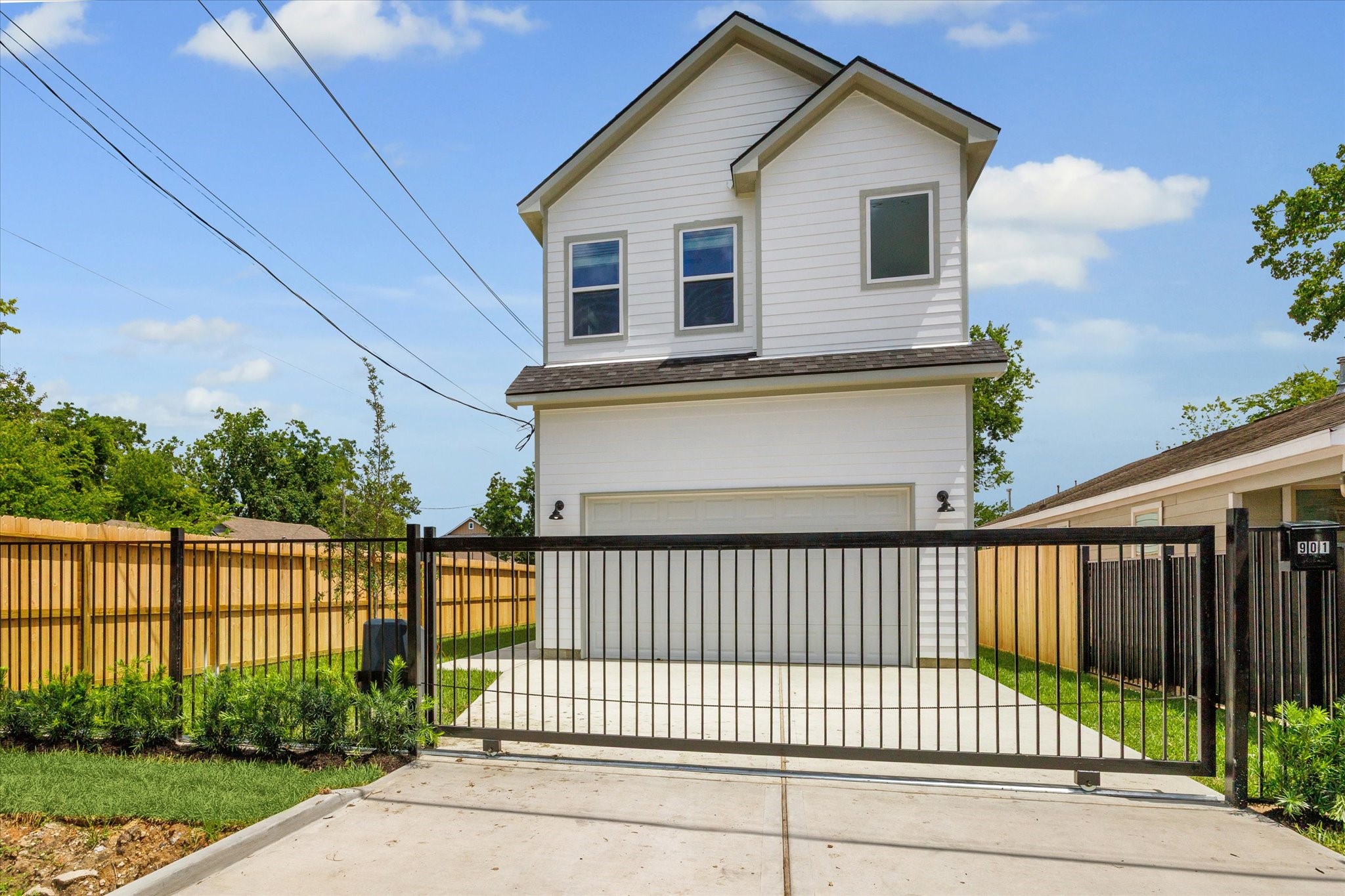901 East 37th Street Houston, TX 77022 - Photo 2 of 19 a view of a white house with a small yard and wooden fence
