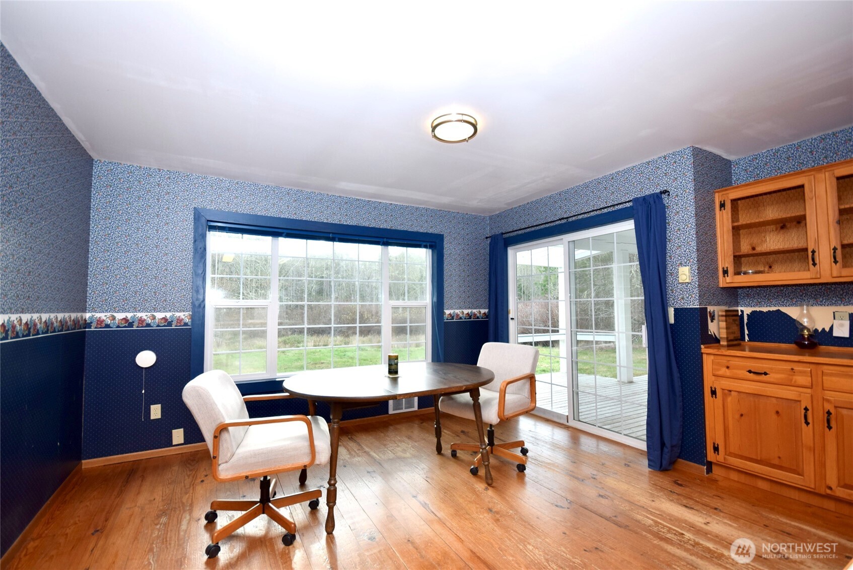 323 Critter Country Trail Sequim, WA 98382 - Photo 14 of 37 a living room with furniture and a floor to ceiling window