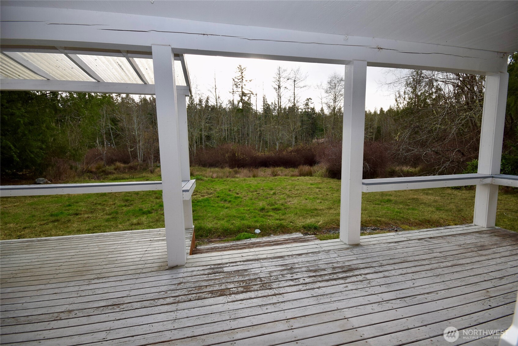 323 Critter Country Trail Sequim, WA 98382 - Photo 25 of 37 a view of a room with wooden floor and a yard
