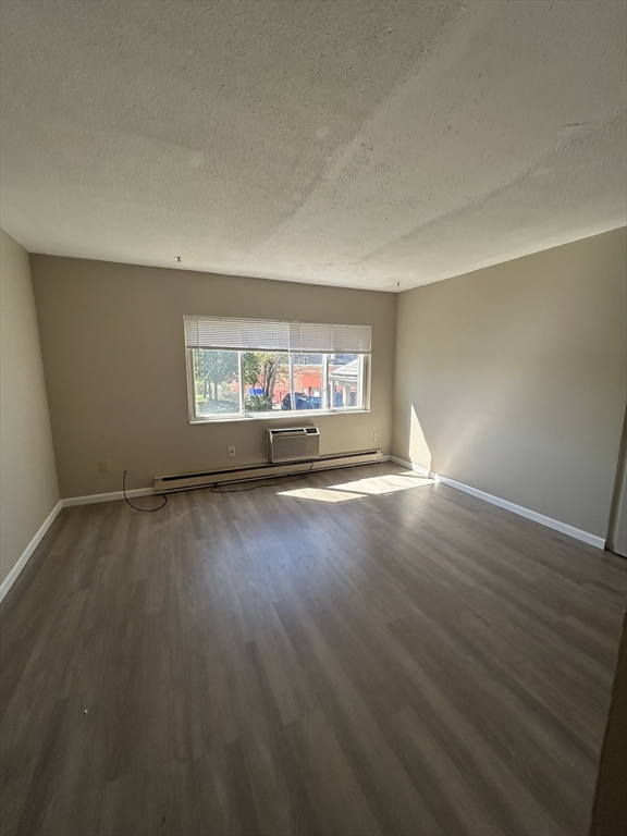71 Pond Street, Unit 21A Quincy, MA 02169 - Photo 3 of 9 wooden floor in an empty room with a window