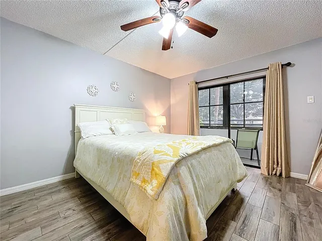 a bedroom with a bed and a flat tv screen on dresser