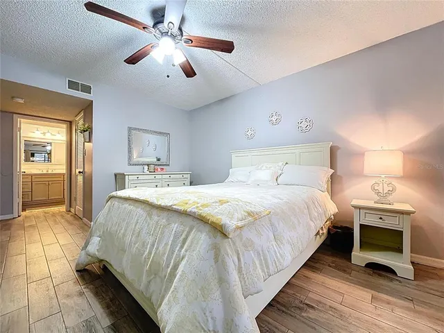 a bathroom with a toilet sink a mirror and shower curtain