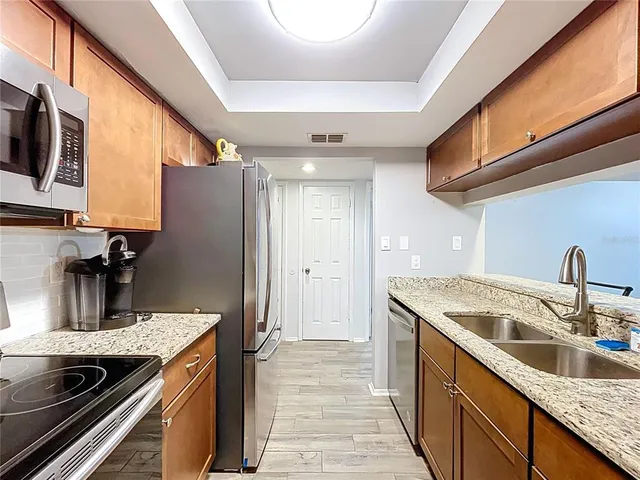 a view of a refrigerator in kitchen and wooden floor