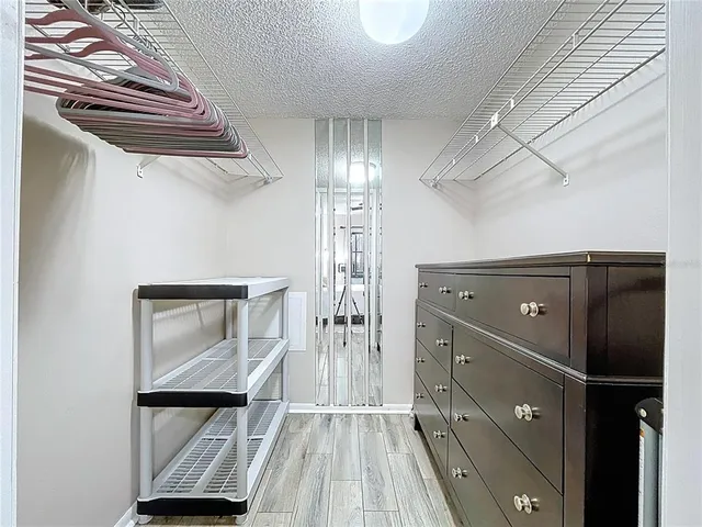 a view of walk in closet with empty racks