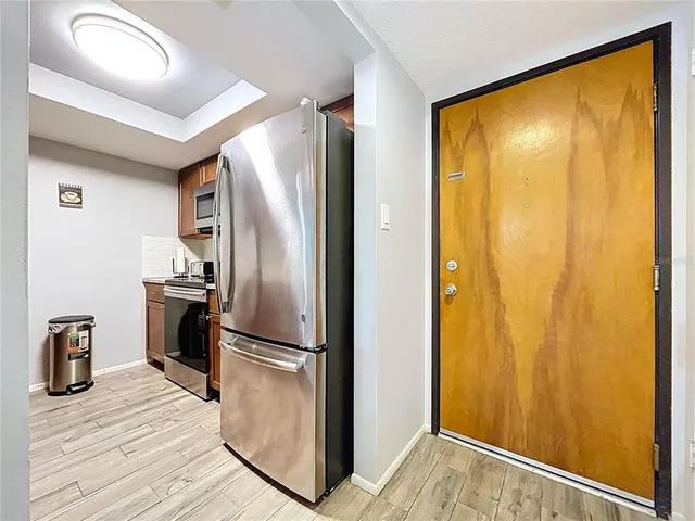 a kitchen with stainless steel appliances granite countertop a stove microwave and sink