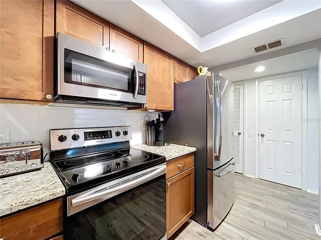a kitchen with a sink a counter space and cabinets
