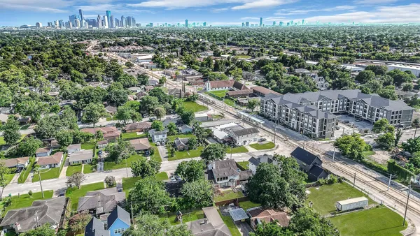 an aerial view of residential houses with outdoor space