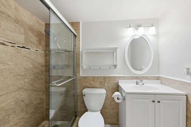 a bathroom with a toilet sink and a mirror