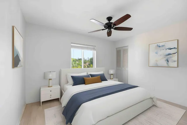 a bedroom with a large bed and a window