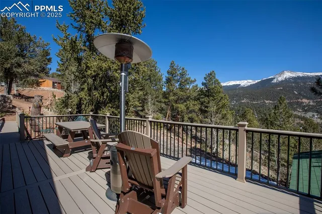 a view of a balcony with wooden floor and outdoor seating