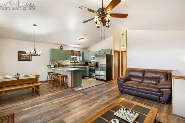 a living room with furniture and kitchen view