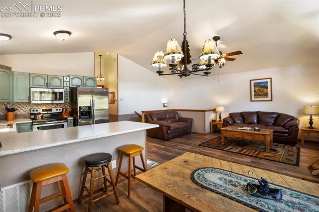 a living room with furniture and a chandelier