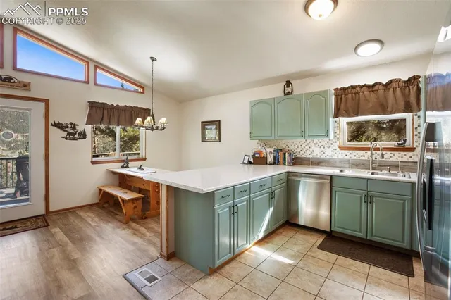 a kitchen with stainless steel appliances granite countertop a sink and a stove