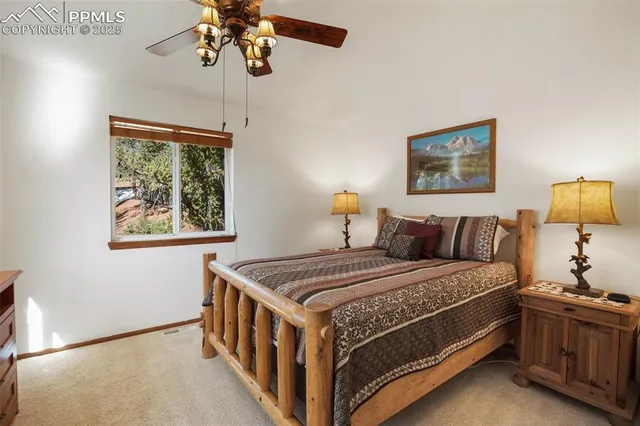 a bedroom with bed and a chandelier