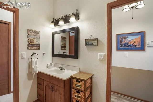 a bathroom with a sink vanity and a mirror