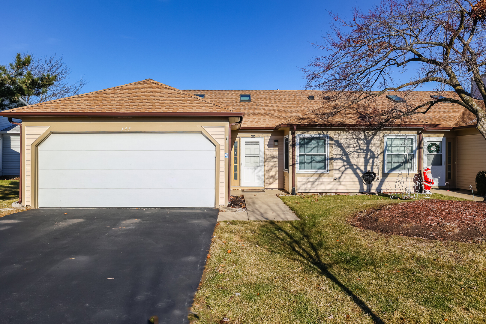 347 Juniper Circle Streamwood, IL 60107 - Photo 1 of 23 a front view of a house with a yard and garage
