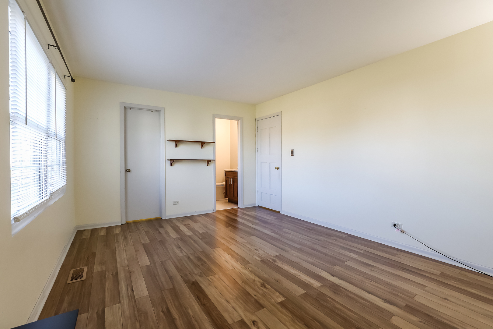 347 Juniper Circle Streamwood, IL 60107 - Photo 14 of 23 a view of empty room with wooden floor and windows