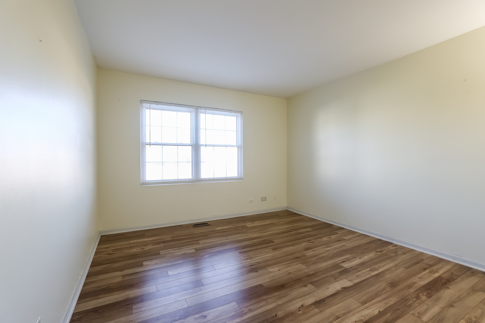347 Juniper Circle Streamwood, IL 60107 - Photo 18 of 23 an empty room with wooden floor and windows