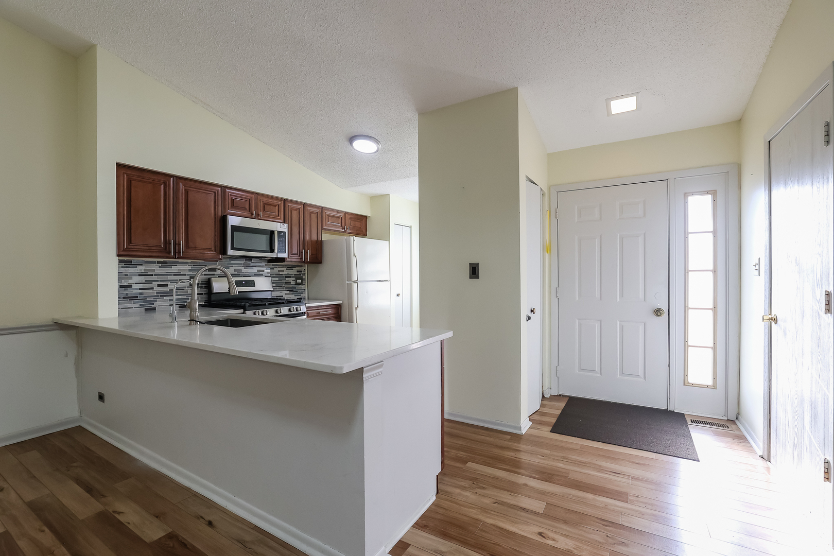 347 Juniper Circle Streamwood, IL 60107 - Photo 2 of 23 a kitchen with stainless steel appliances a refrigerator sink and microwave