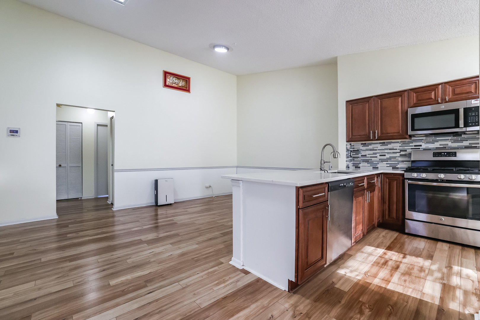 347 Juniper Circle Streamwood, IL 60107 - Photo 3 of 23 a kitchen with granite countertop a stove and a microwave