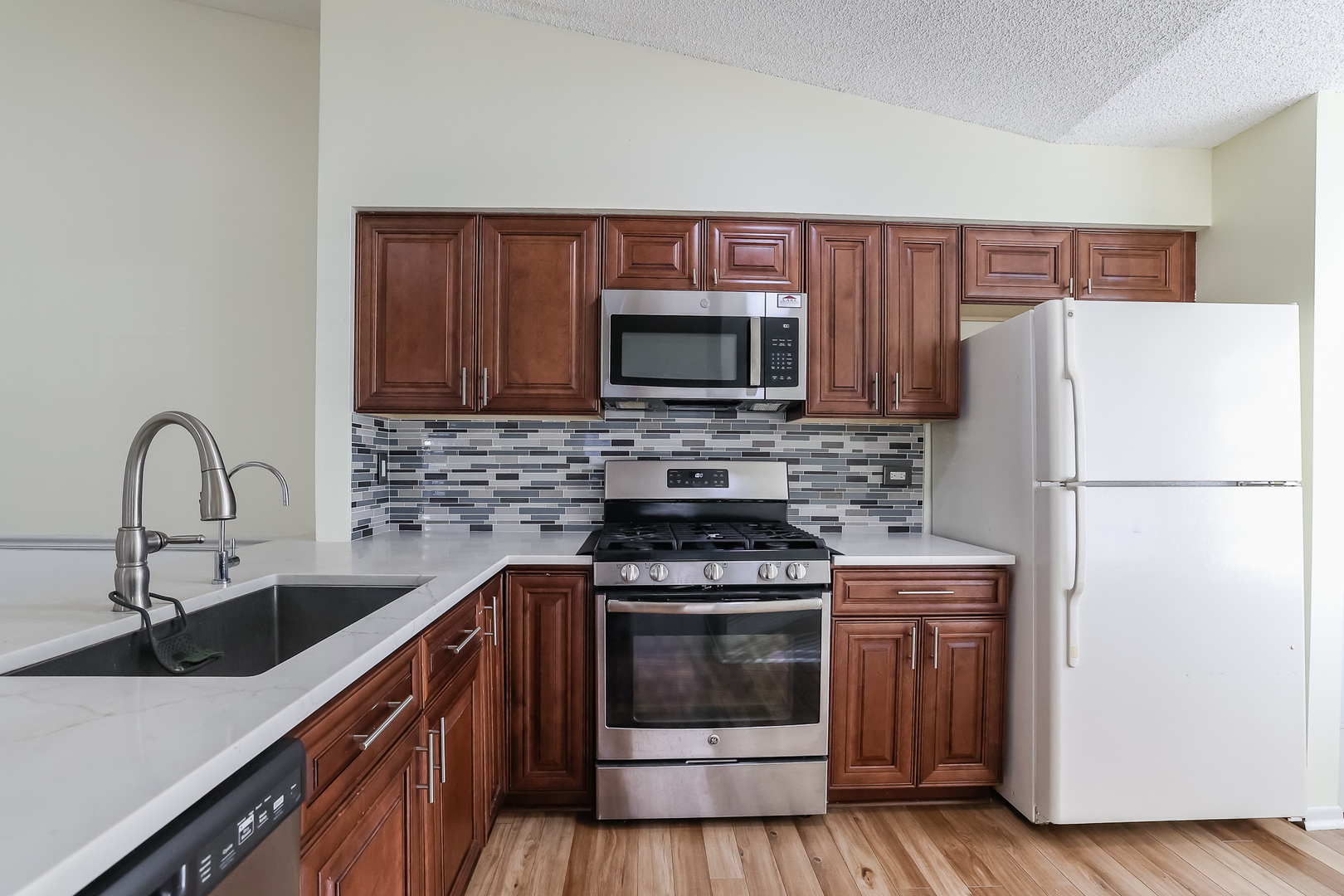 347 Juniper Circle Streamwood, IL 60107 - Photo 4 of 23 a kitchen with a sink stove and refrigerator