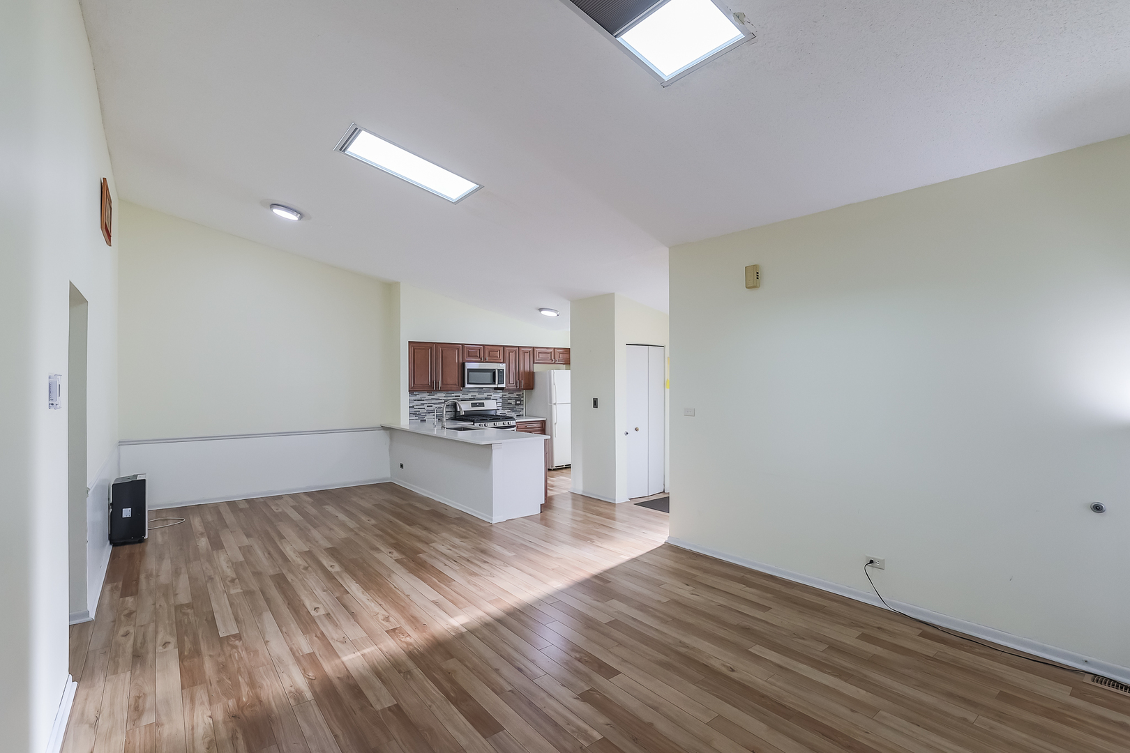 347 Juniper Circle Streamwood, IL 60107 - Photo 8 of 23 a living room with a wooden floor and a ceiling fan