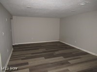 6439 Wadsworth Road Medina, OH 44256 - Photo 13 of 14 Unfurnished room featuring baseboards and dark wood-style flooring