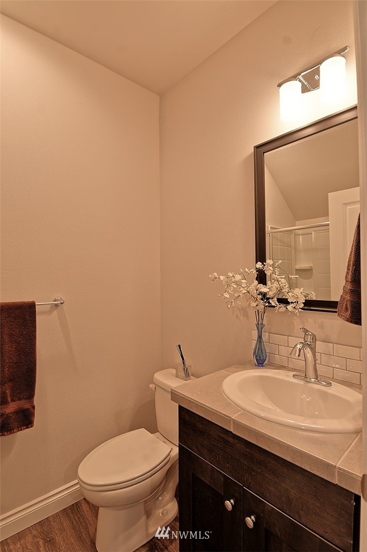 20322 85th Place Northeast Bothell, WA 98011 - Photo 14 of 24 a bathroom with a granite countertop sink and a mirror