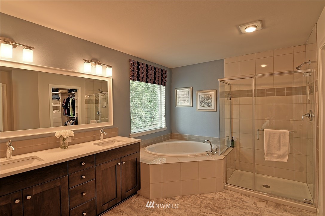 20322 85th Place Northeast Bothell, WA 98011 - Photo 17 of 24 a spacious bathroom with a tub sink shower and mirror