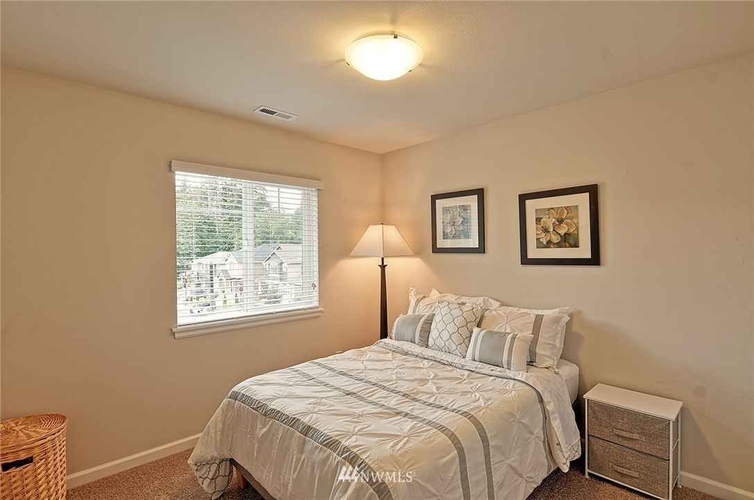 20322 85th Place Northeast Bothell, WA 98011 - Photo 18 of 24 a bedroom with a bed and a window