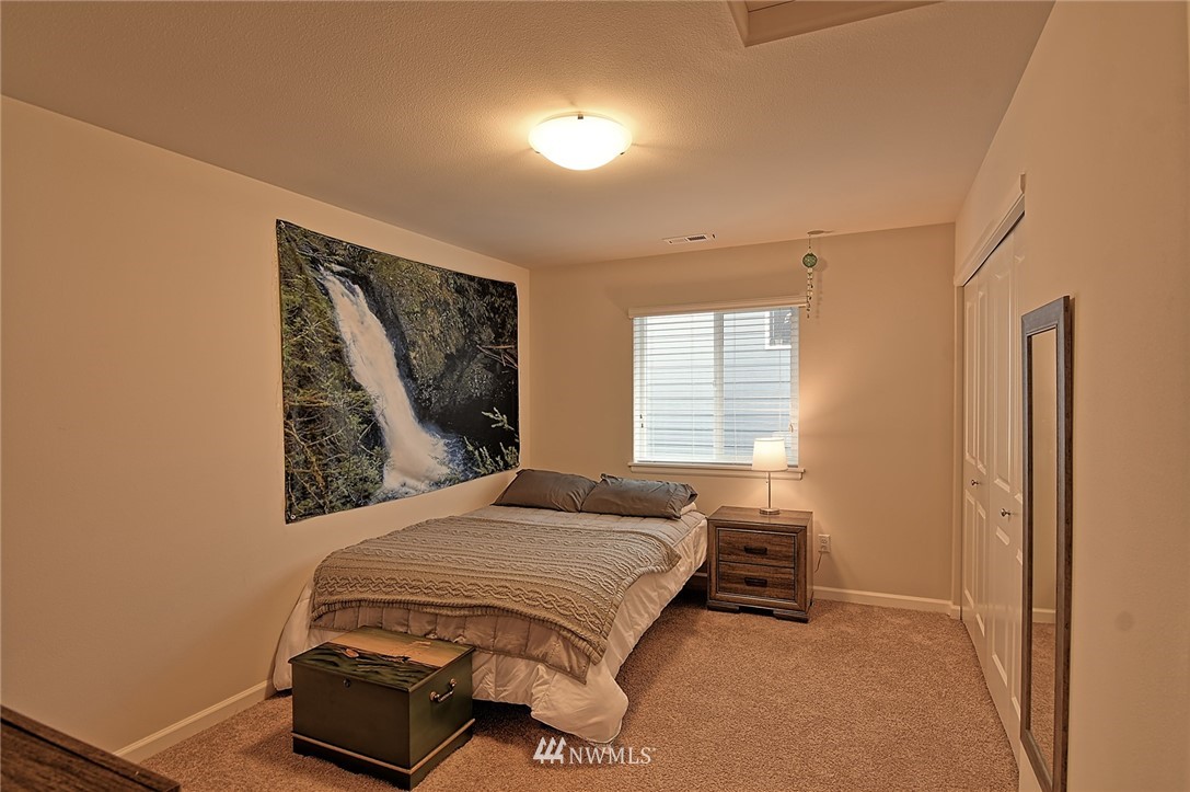 20322 85th Place Northeast Bothell, WA 98011 - Photo 19 of 24 a bedroom with a bed and a window