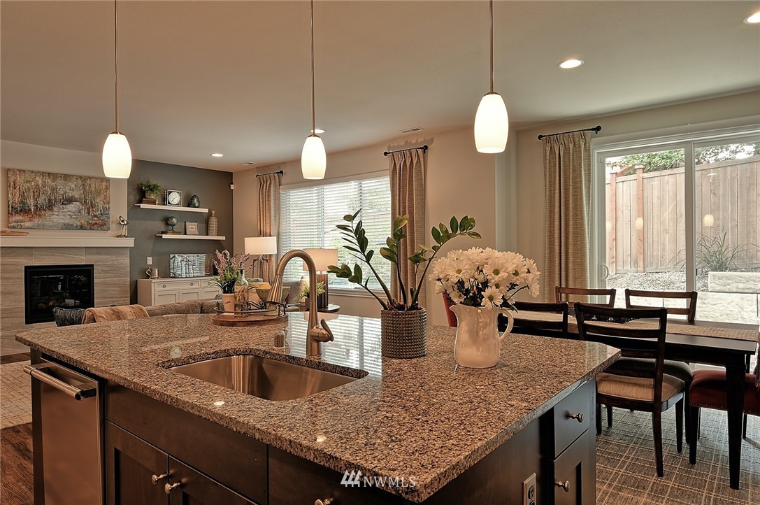 20322 85th Place Northeast Bothell, WA 98011 - Photo 3 of 24 a kitchen with a counter space a sink cabinets and living room view