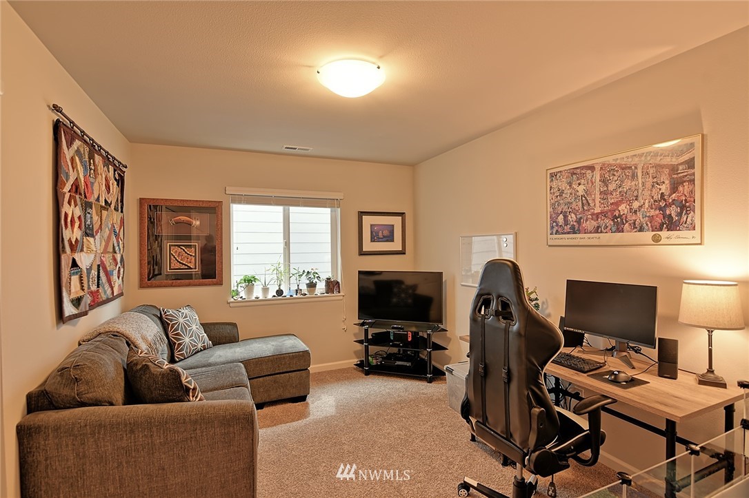 20322 85th Place Northeast Bothell, WA 98011 - Photo 21 of 24 a livingroom with workspace and a couch