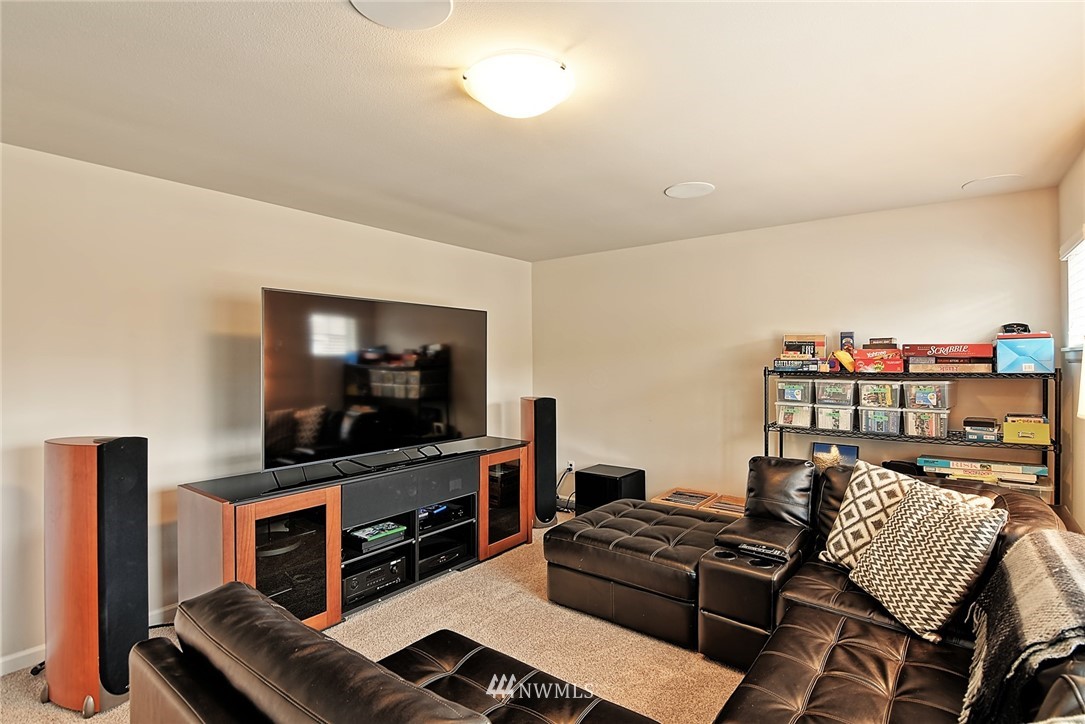 20322 85th Place Northeast Bothell, WA 98011 - Photo 22 of 24 a living room with furniture and a flat screen tv