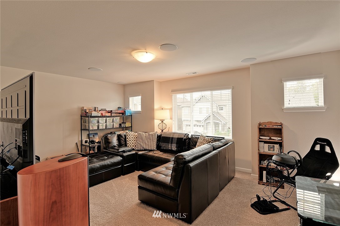 20322 85th Place Northeast Bothell, WA 98011 - Photo 23 of 24 a living room with furniture and a flat screen tv