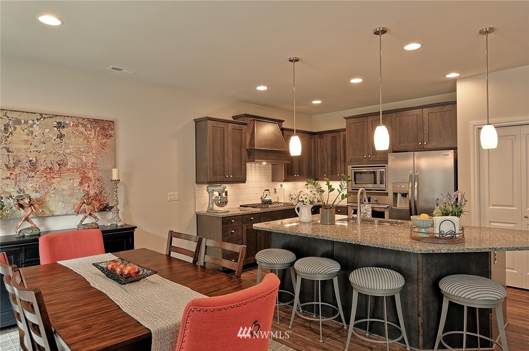 20322 85th Place Northeast Bothell, WA 98011 - Photo 4 of 24 a kitchen with a dining table chairs and view kitchen