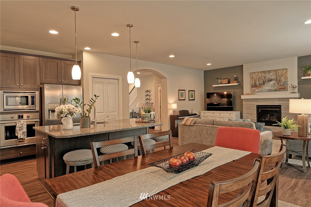 20322 85th Place Northeast Bothell, WA 98011 - Photo 6 of 24 a kitchen with a table chairs stove and kitchen view