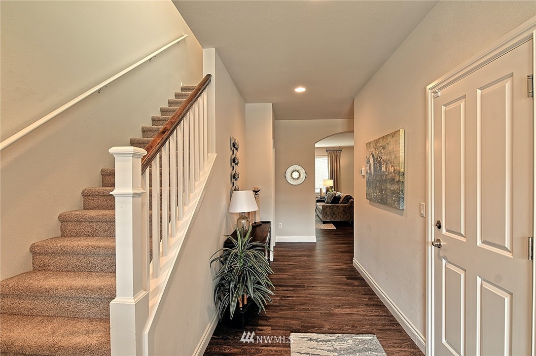 20322 85th Place Northeast Bothell, WA 98011 - Photo 7 of 24 a view of a hallway with wooden floor and staircase