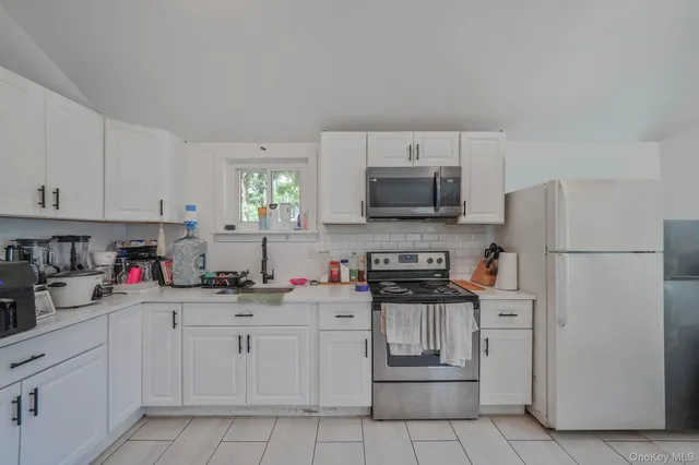 a kitchen with cabinets stainless steel appliances and a counter space