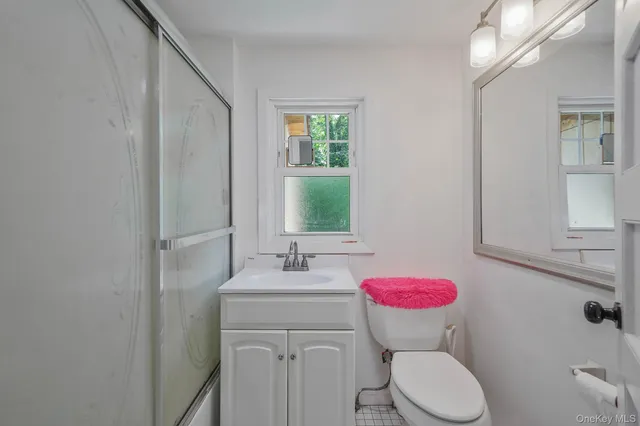 a bathroom with a sink mirror vanity and toilet