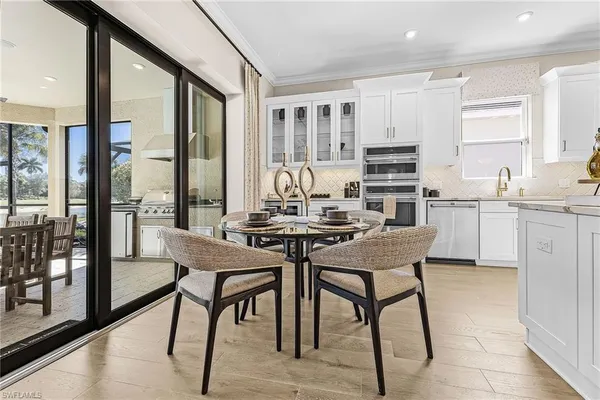 a view of a dining room with furniture and wooden floor