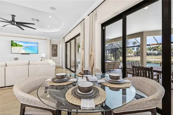 a living room with hard wood floor furniture and a large window