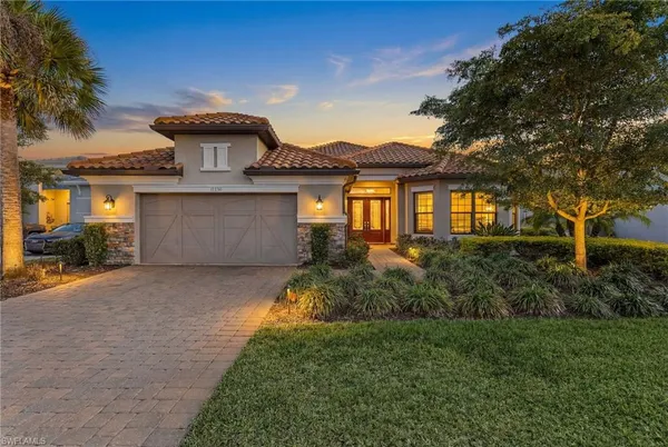 a front view of a house with a yard and garage