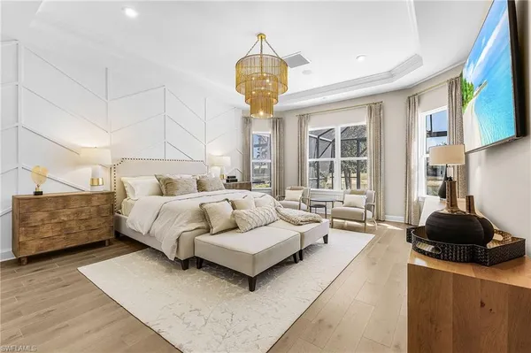 a bedroom with a bed and a chandelier